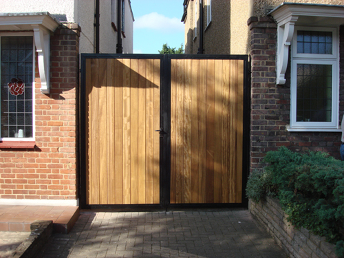 A pair of wooden side gates in wrought iron frame for extra security.