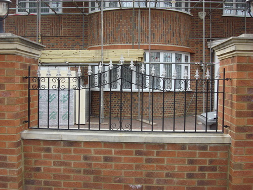 Thin green wrought iron railings